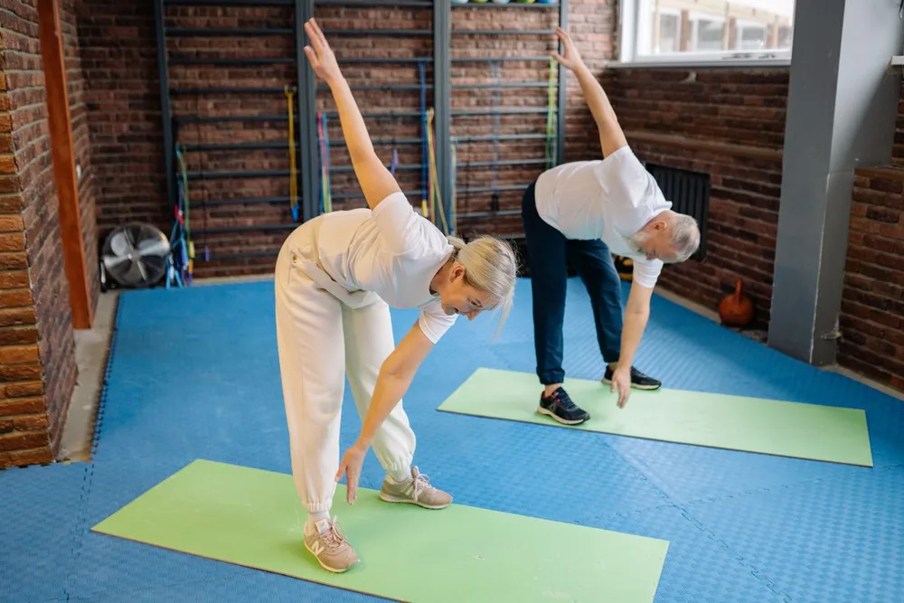 Active older adults stretching outdoors