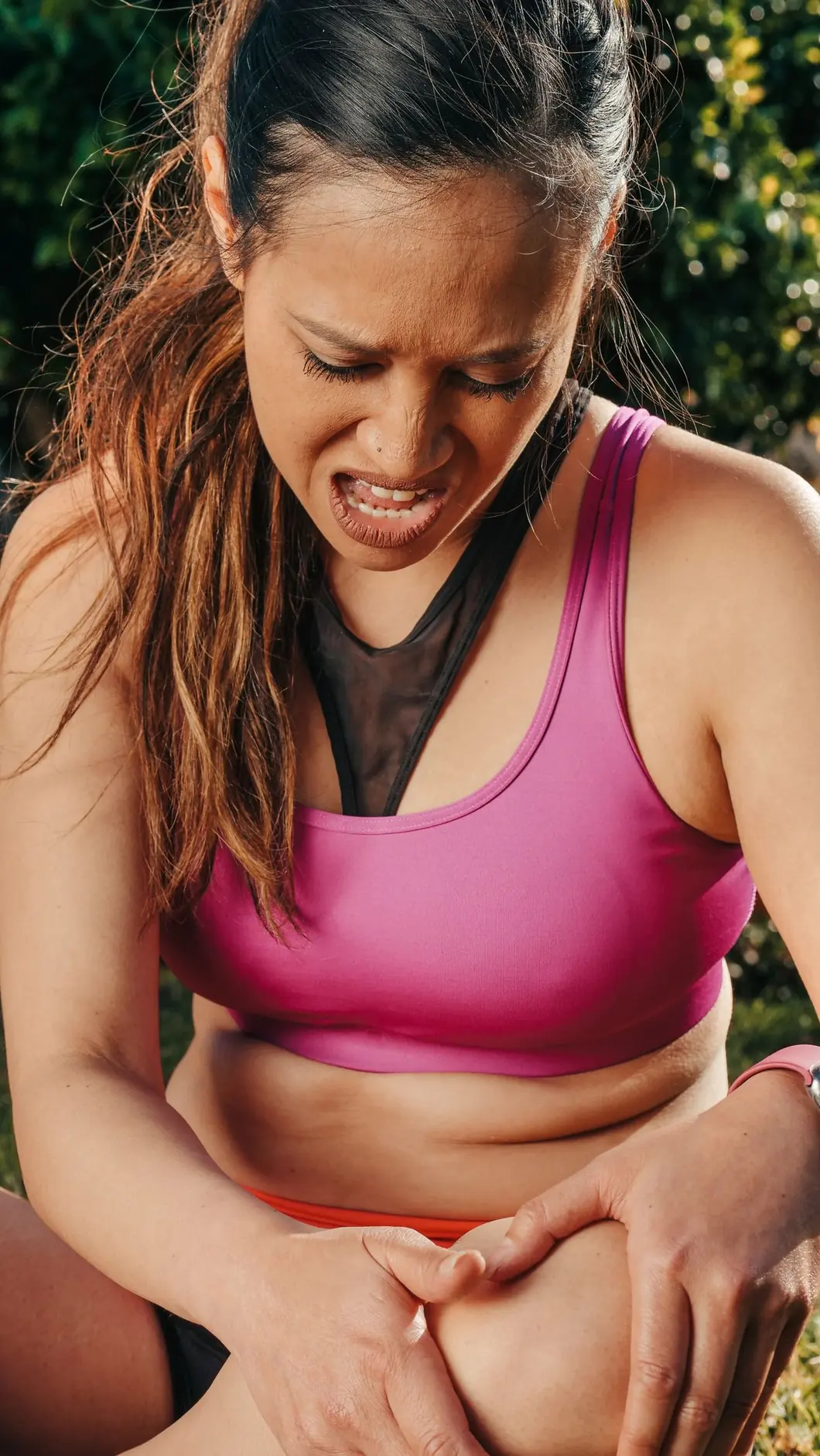 Close-up of a person holding their knee due to joint discomfort
